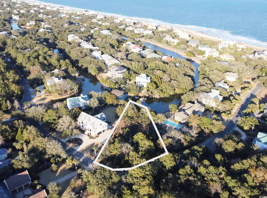 Birds eye view of property featuring a water view and a view of the beach