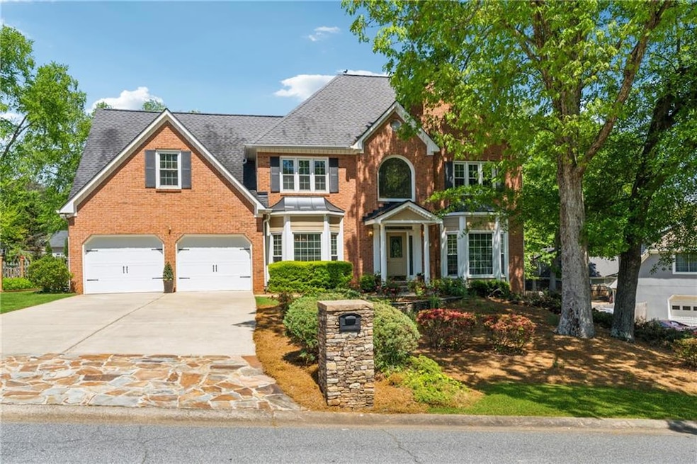 View of front of home with a garage, a shingled ro