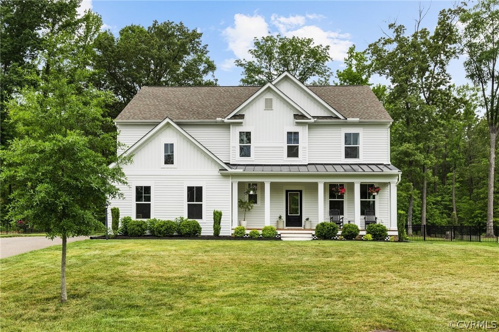 Modern inspired farmhouse with a front yard and a