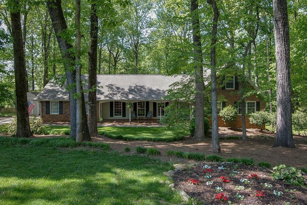 Beautifully landscaped and maintained yard with ma