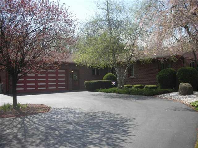 Exterior Front. beautiful L-shaped all brick ranch.