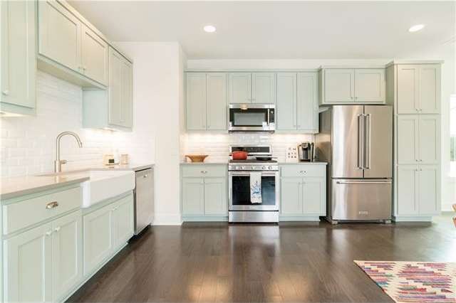 Open L-Shaped Kitchen on 2nd floor with wood floor