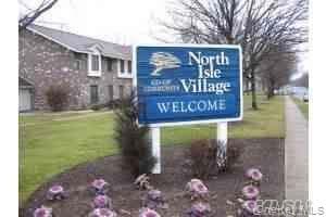 Community / neighborhood sign with a yard