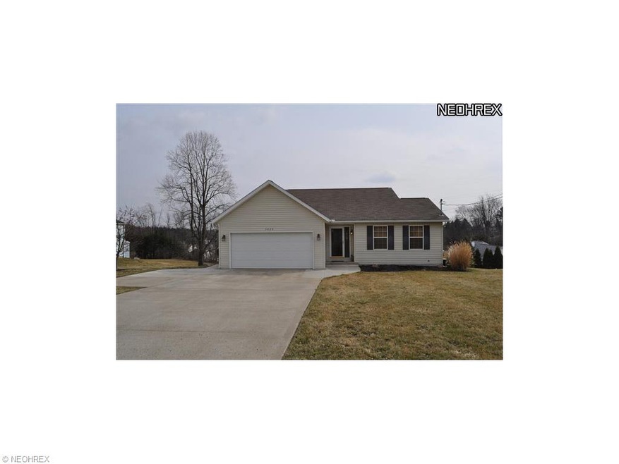 front view with new concrete driveway in front of 