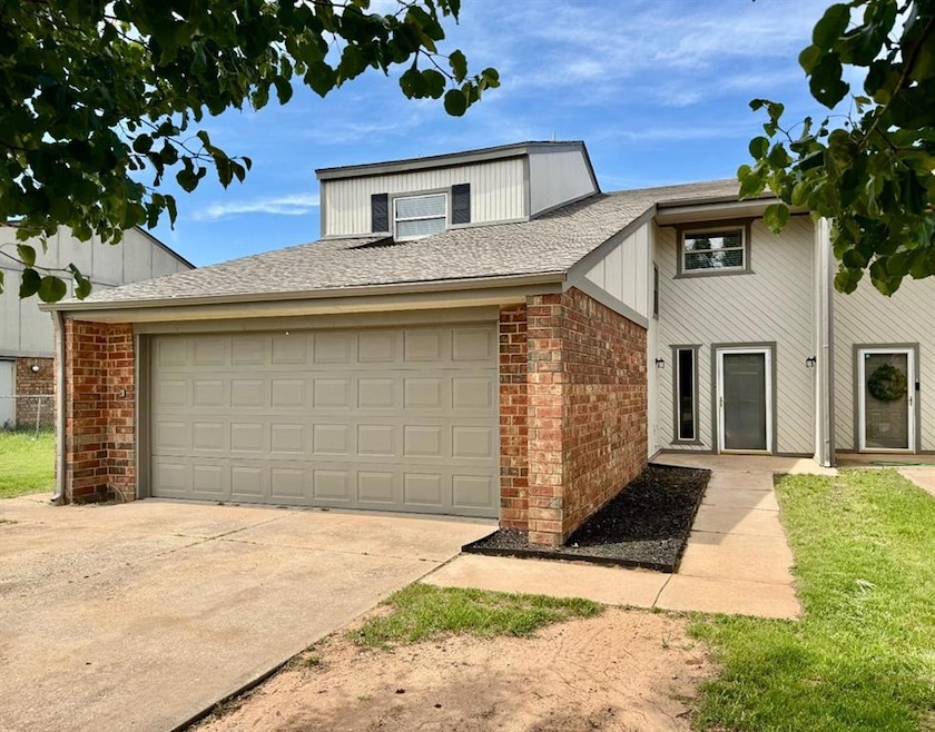 View of front of property with brick siding, an at