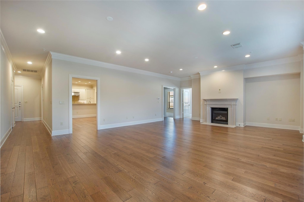 Unfurnished living room featuring ornamental moldi