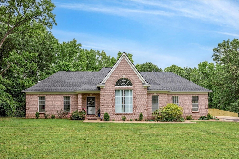 View of front facade featuring brick siding, a fro