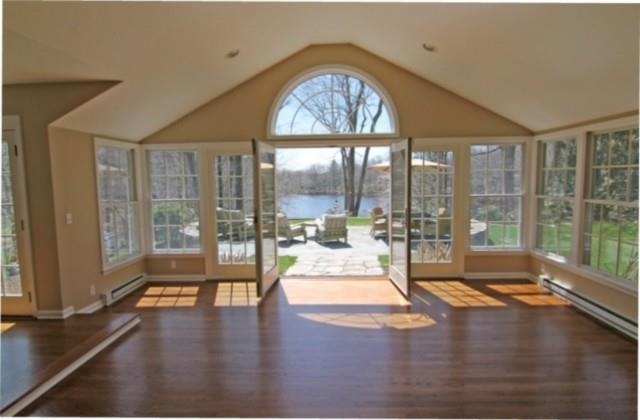 Sunroom looking out to stone patio and lake