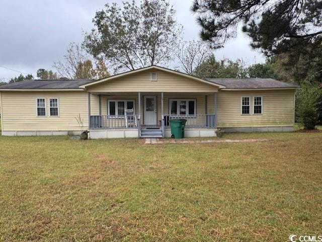 View of front of house featuring a porch and a front lawn