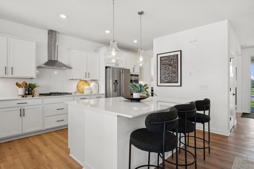 (Photo of model home, finishes will vary) The spacious kitchen naturally serves as the heart of this home, complete with a generous center island, brand-new appliances and a walk-in pantry.