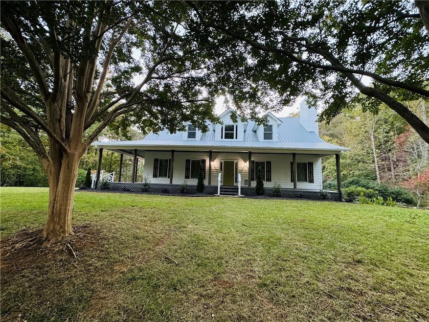 Farmhouse featuring a front lawn and covered porch