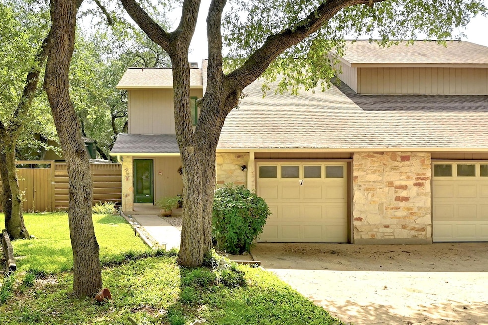 View of front facade featuring stone siding, roof