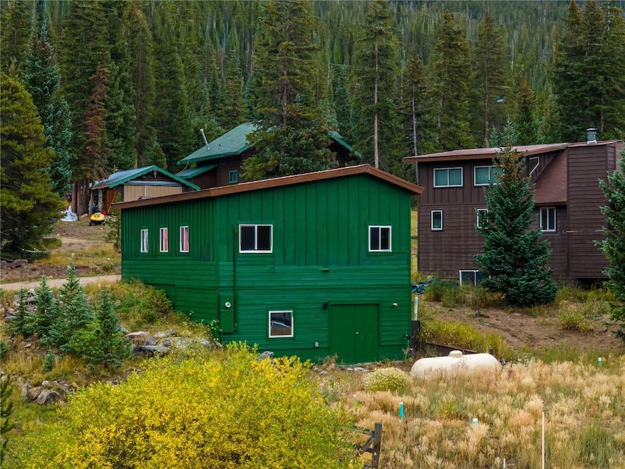 View of home's exterior featuring board and batten siding and a wooded view