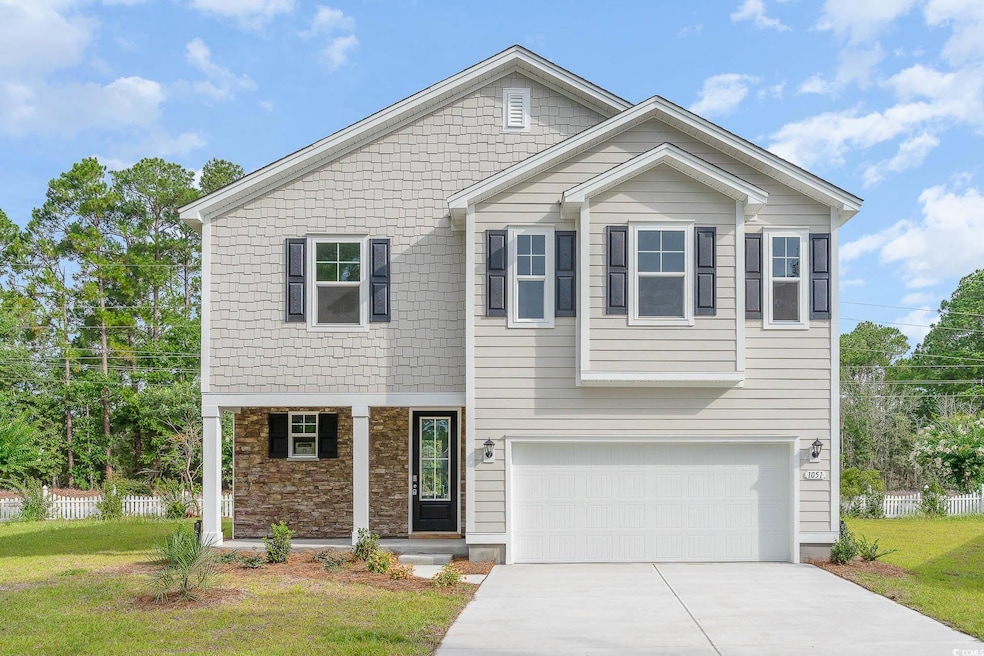 View of front of house featuring driveway, a garag