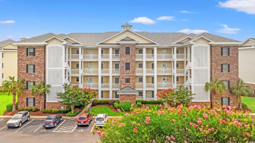 View of property featuring uncovered parking
