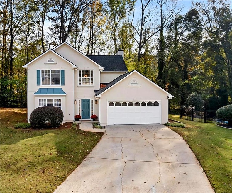 The front exterior exudes timeless curb appeal wit