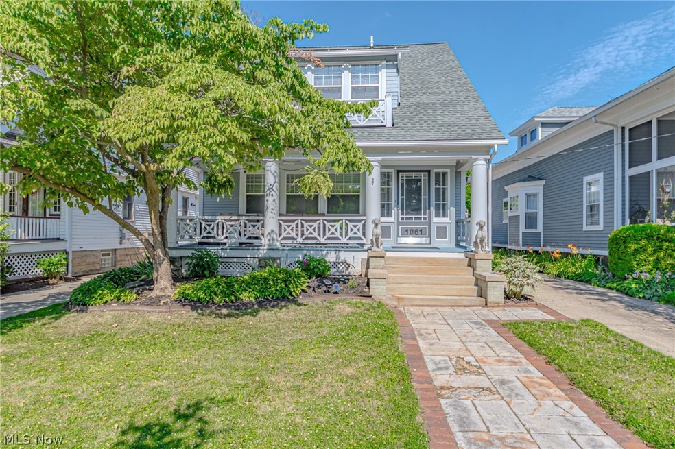 View of front facade with a front lawn and covered porch