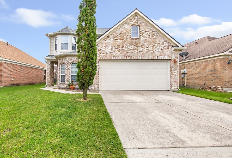 This photo shows a charming brick house with a two