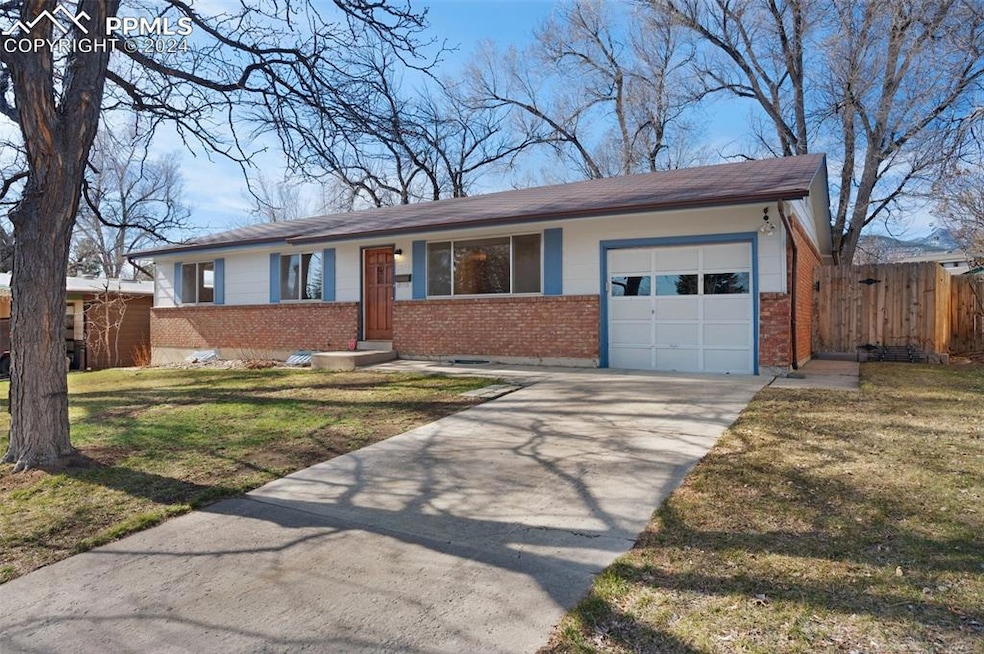 Front of brick rancher with one car garage.