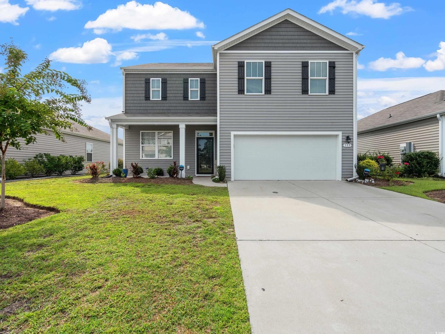 Front facade with a front yard and a garage