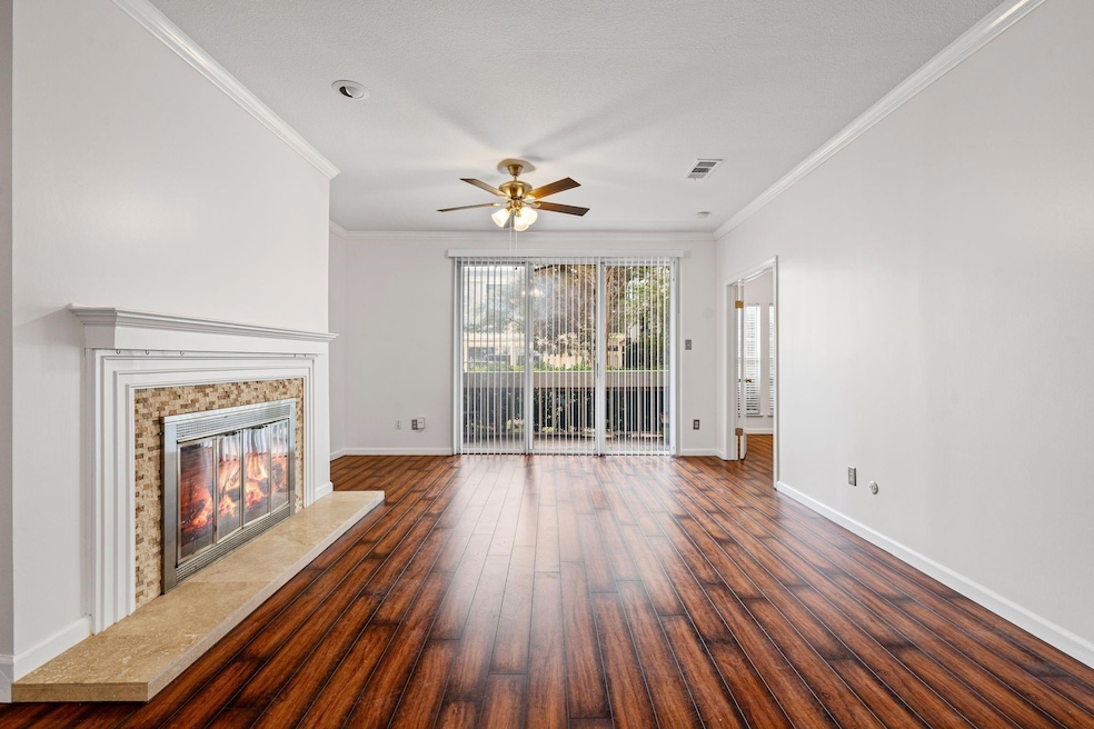Unfurnished living room with ornamental molding, d