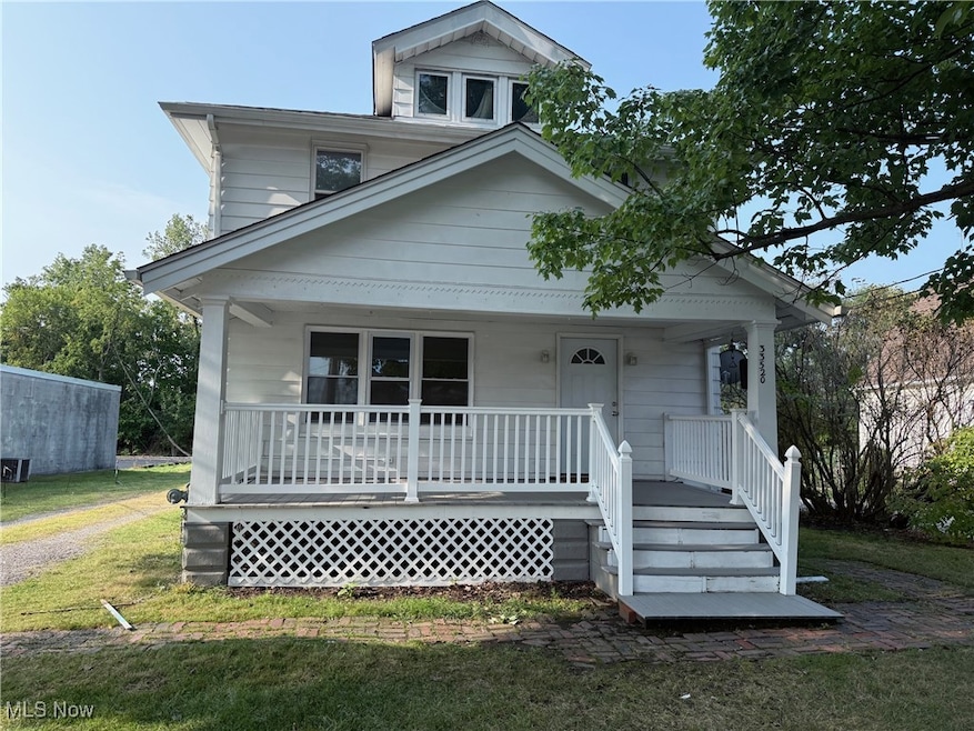 View of front of home featuring covered porch and a front lawn
