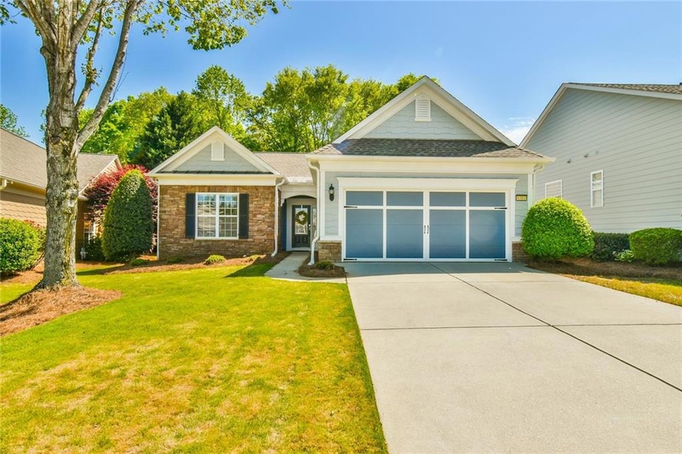 Single story home with a front lawn, driveway, sto