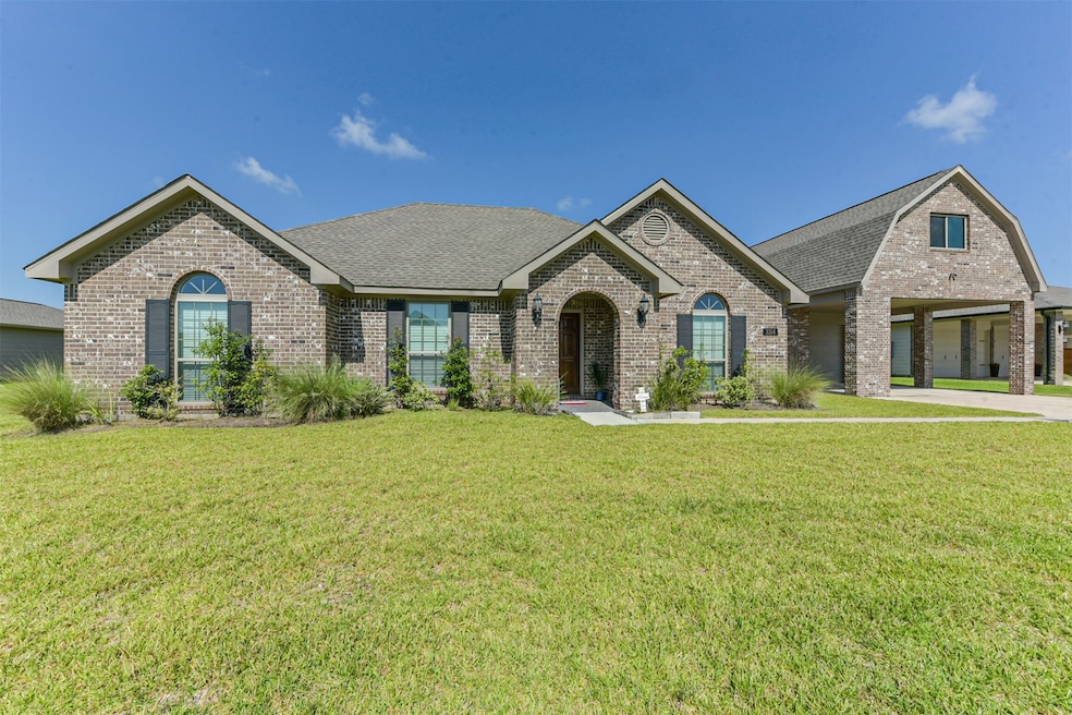 View of oversized garage and carport