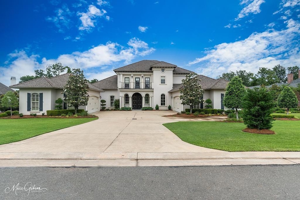 View of front facade with a garage, a balcony, and