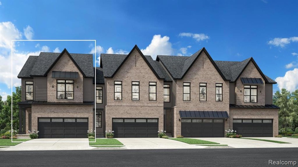 View of front of property featuring concrete driveway, brick siding, and an attached garage