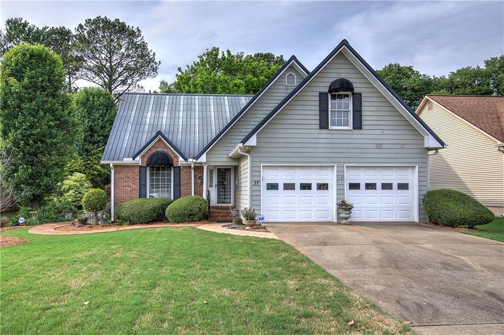 View of front of property with a garage and a fron