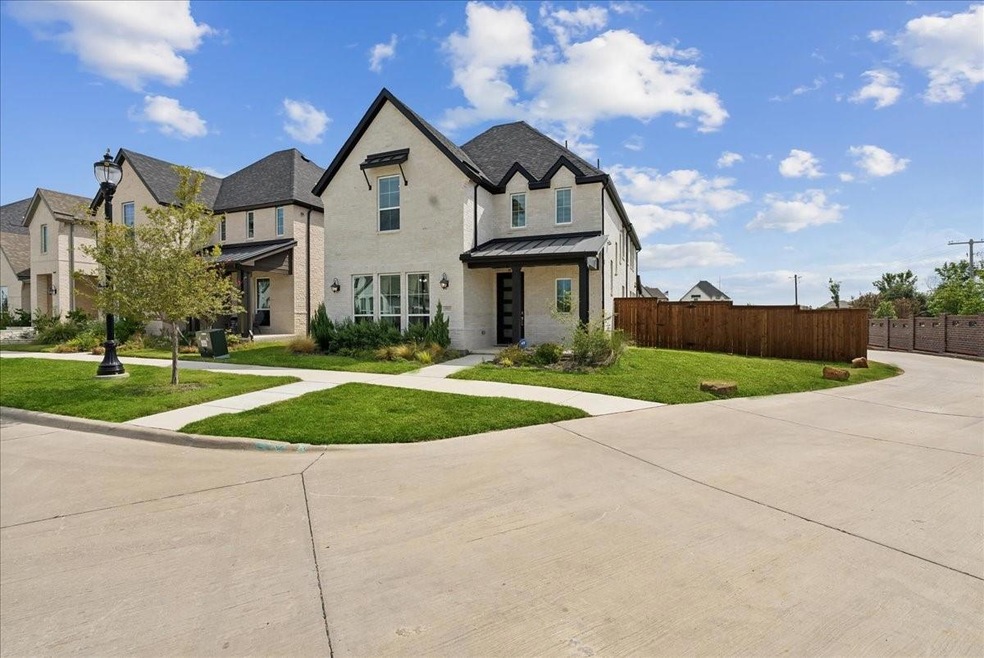 View of front of home with metal roof, fence, a front yard, and a standing seam roof