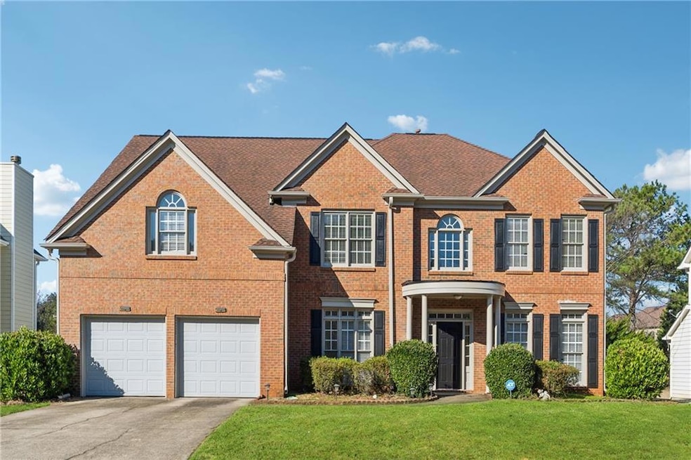 View of front of property with driveway, brick sid