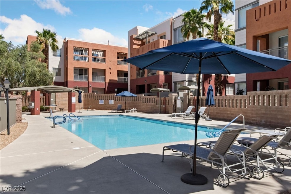 Community pool featuring a patio area and fence