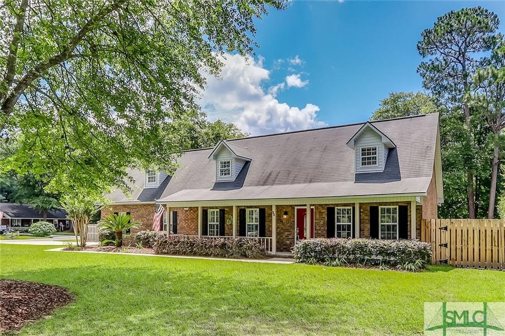 Beautiful front exterior! Mature landscaping, huge porch & shady trees!