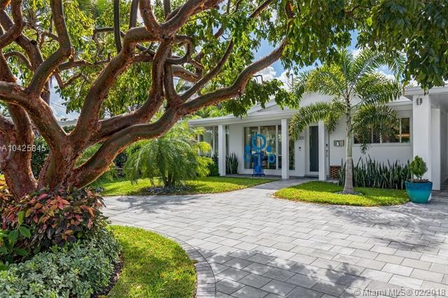 Stunning curb appeal featuring lush landscaping, p
