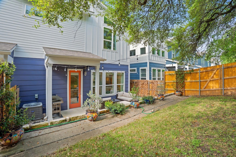 Rear view of property featuring central AC, fence