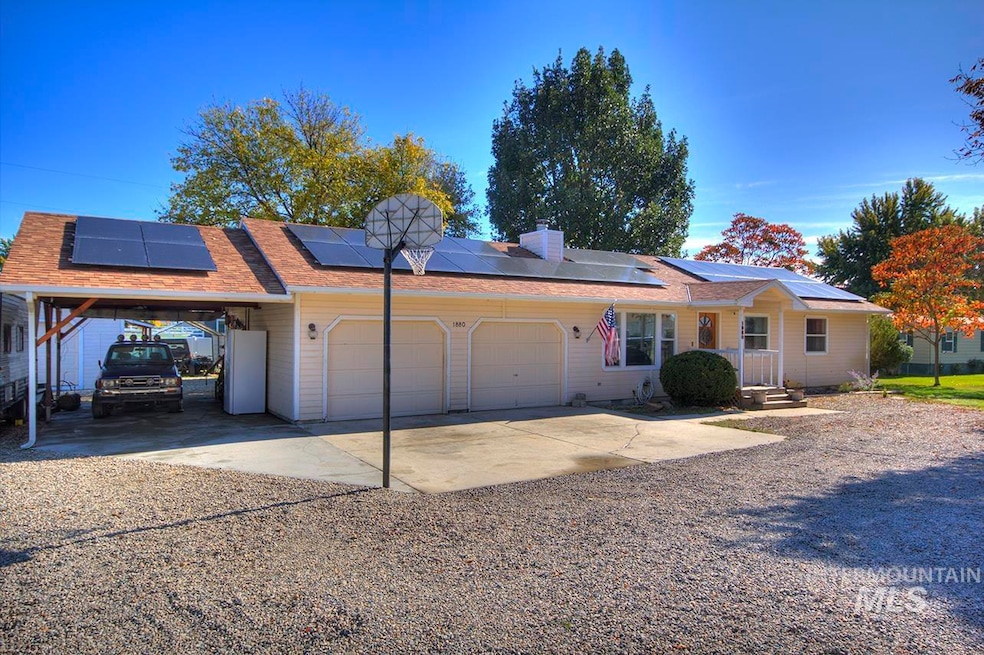 Ranch-style house with driveway, an attached garage, an attached carport, and a chimney