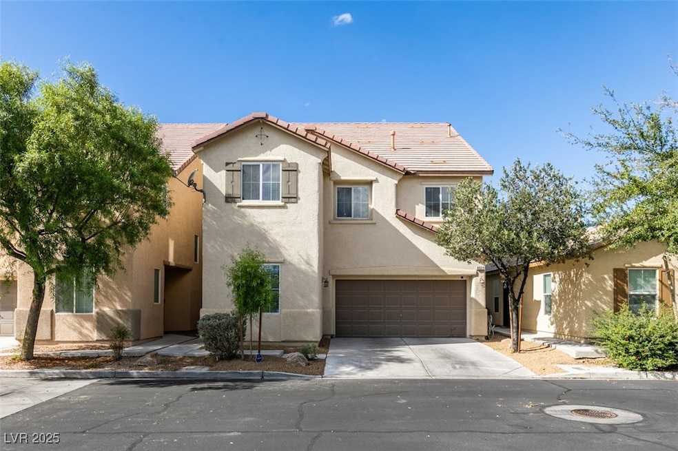 Mediterranean / spanish home with stucco siding, concrete driveway, a tile roof, and an attached garage