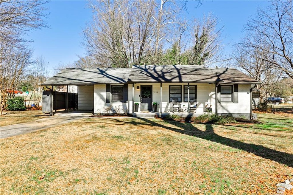 Single story home featuring a carport, a front yar