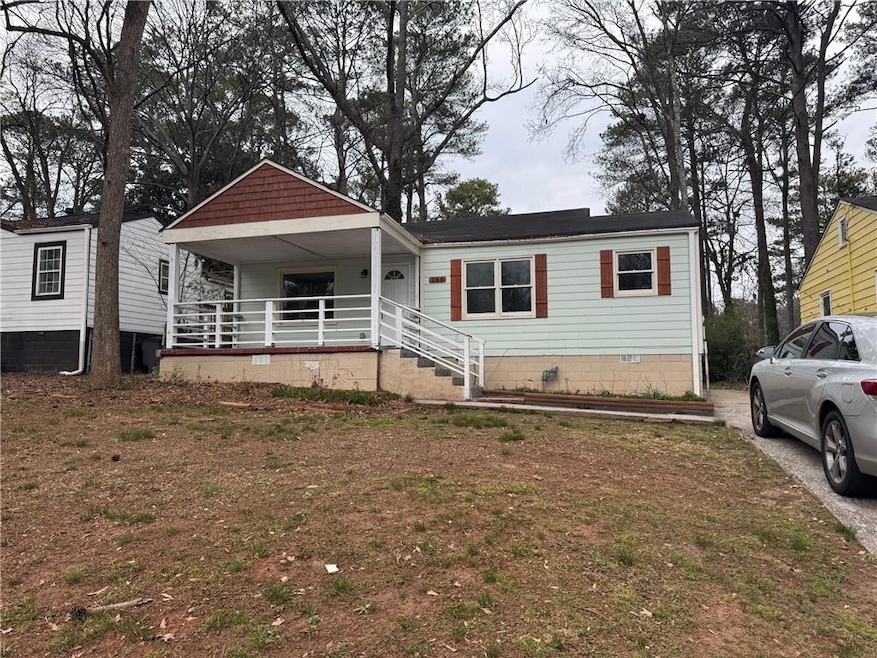 View of front of house with a front yard, a porch,