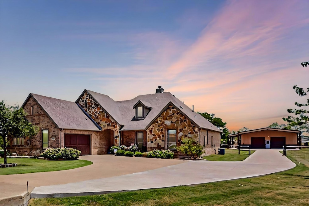 View of front facade with a garage and a lawn