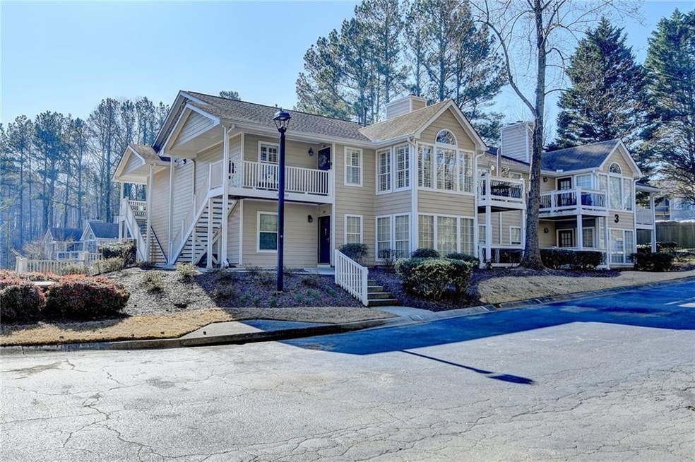 View of front of home featuring stairs and a chimn