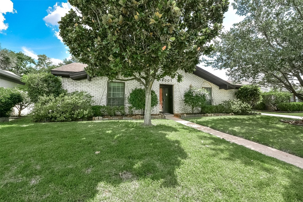 Lovely brick home with mature landscaping.