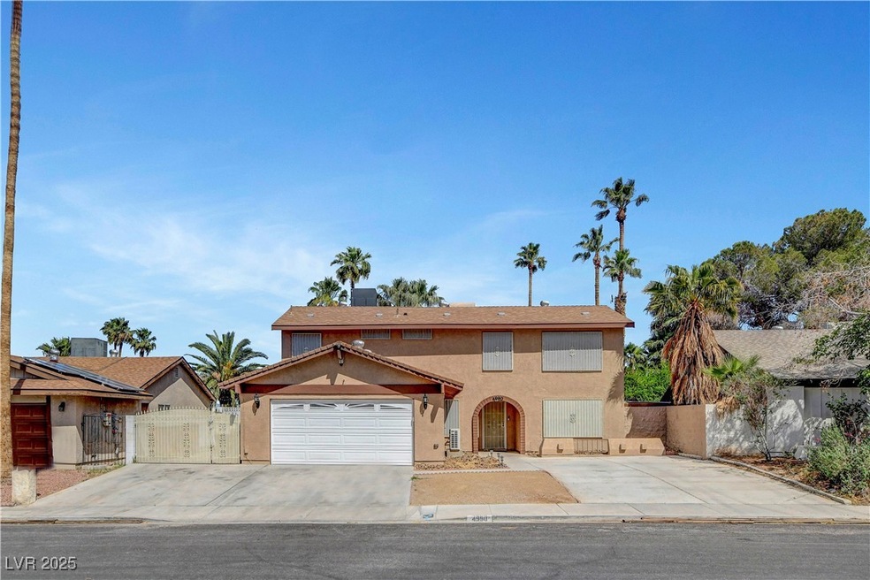 View of front of property featuring a gate, stucco