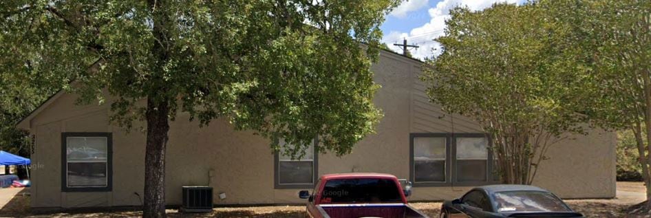 Rear view of property featuring stucco siding and