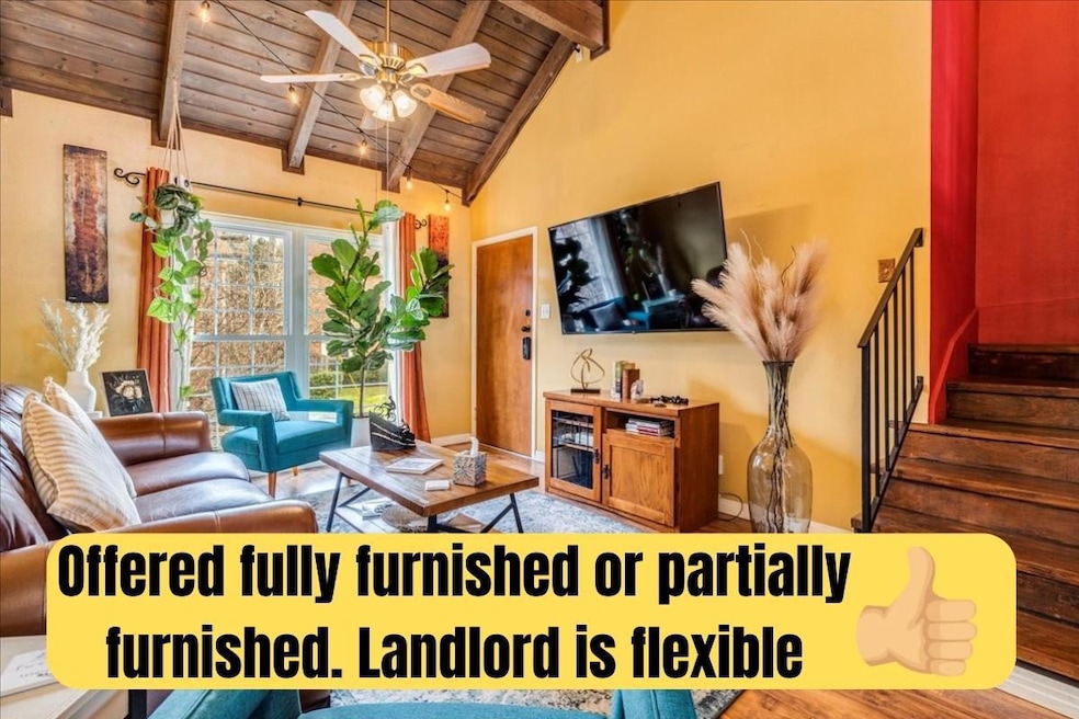 Living room featuring wooden ceiling with exposed