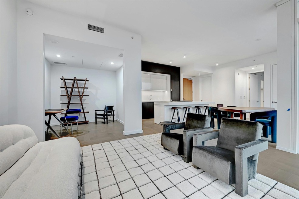 Living area featuring visible vents, baseboards, 