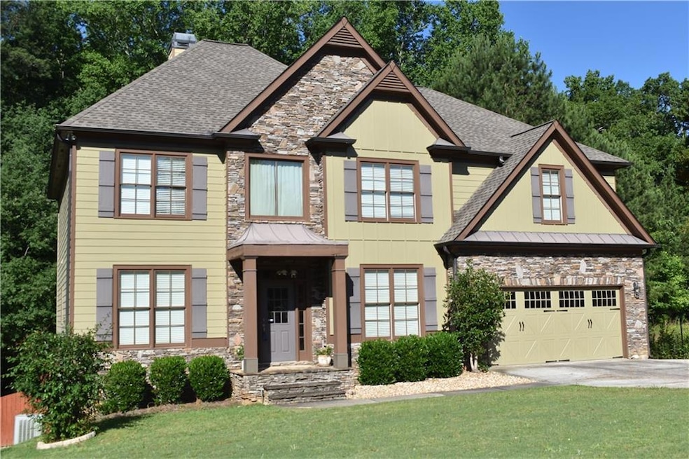 Craftsman-style home with a garage and a front yar