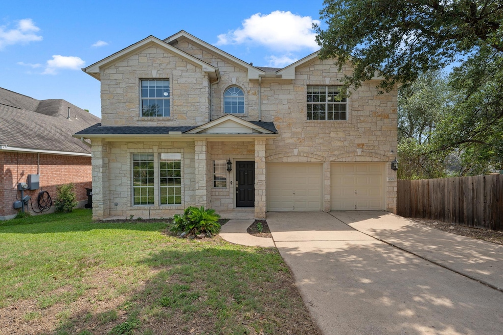 Traditional-style house featuring stone siding, d